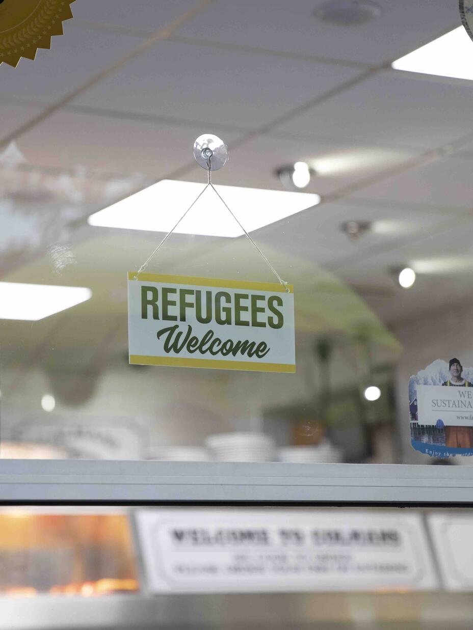 sign in chip shop window saying refugees welcome